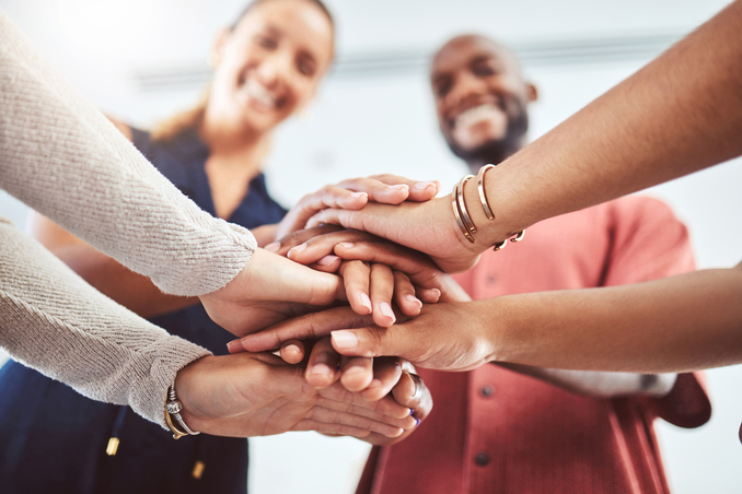 Photo of several hands as a symbol of teamwork